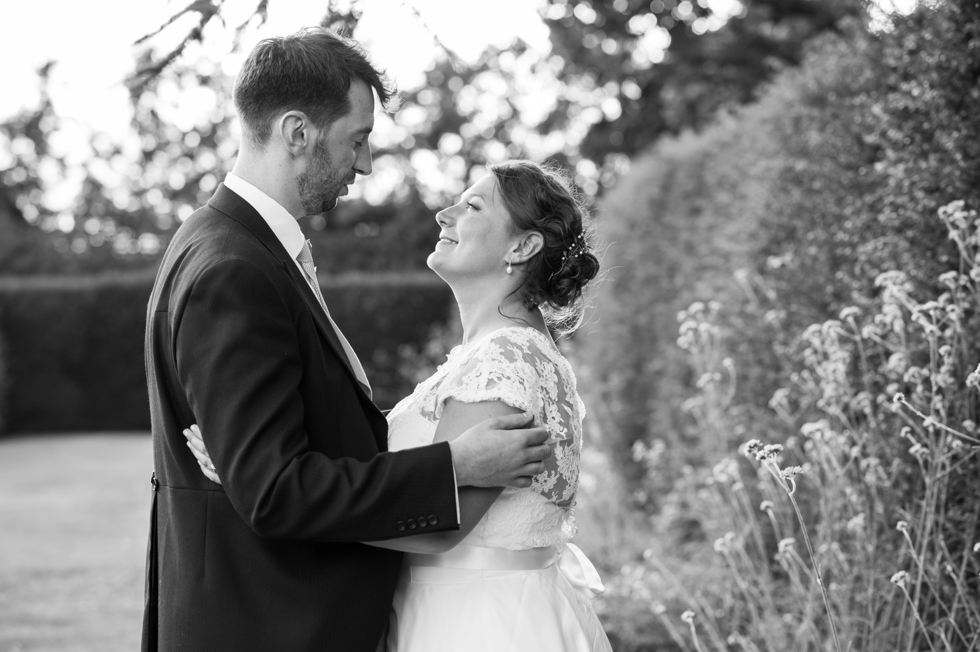 A bride and groom having their wedding photography in the gardens of Whatley Manor